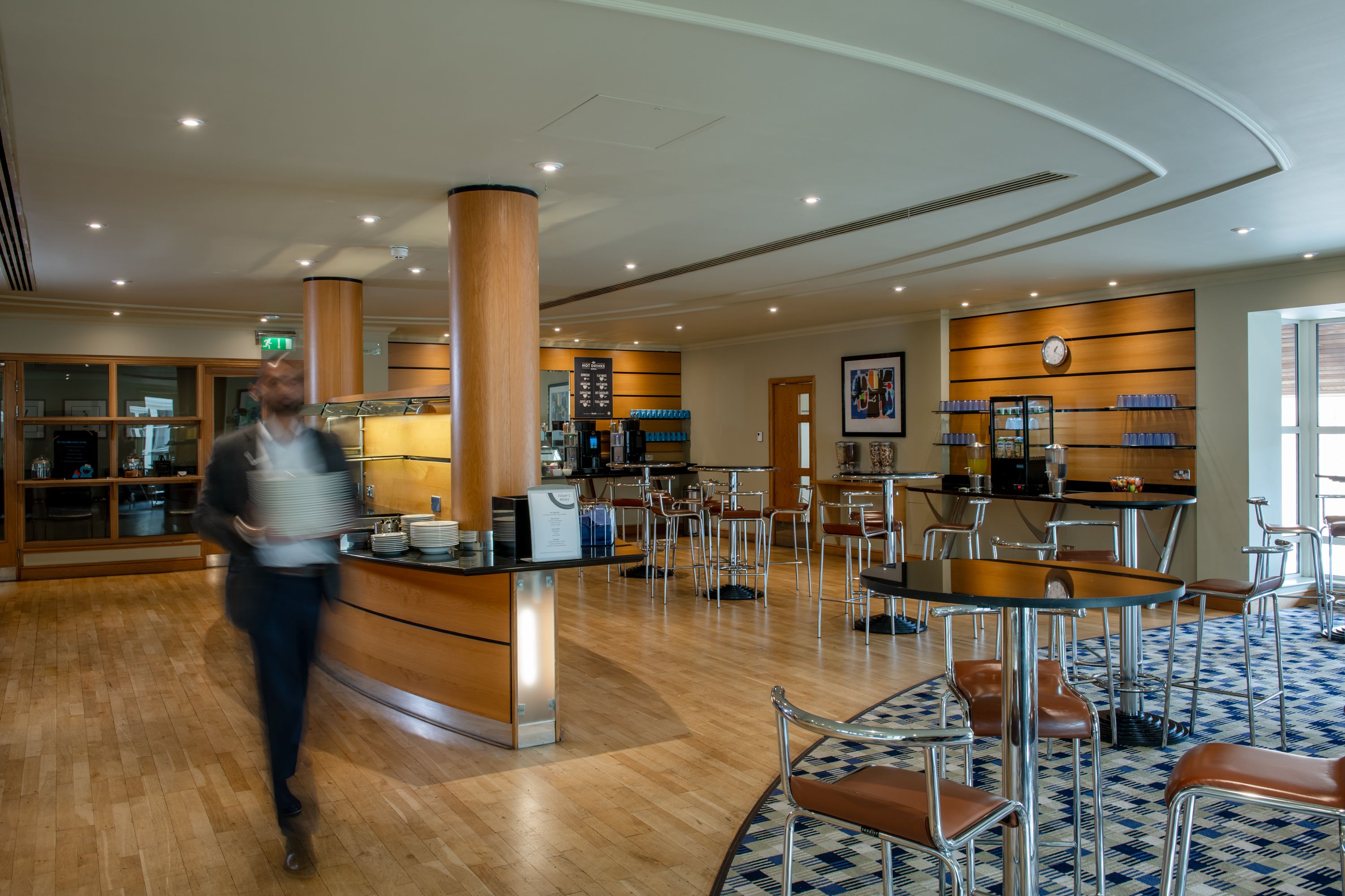 a room with high chairs and a buffet