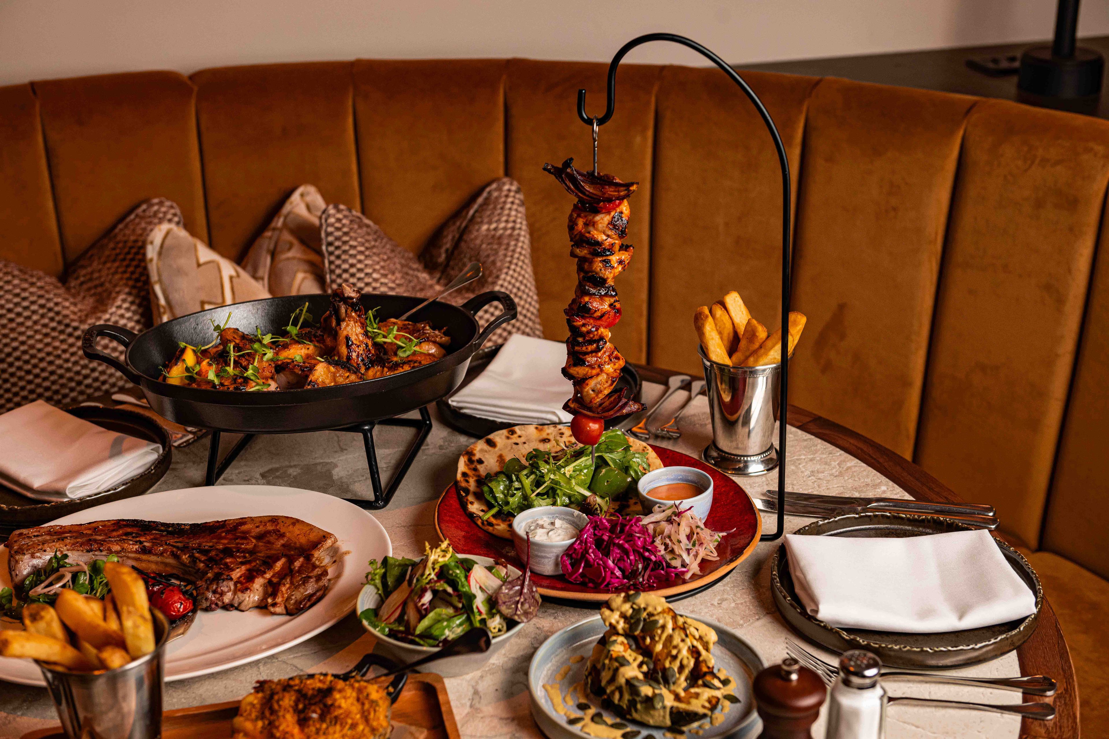 The hanging kebabs , beer can chicken, pork tomahawk