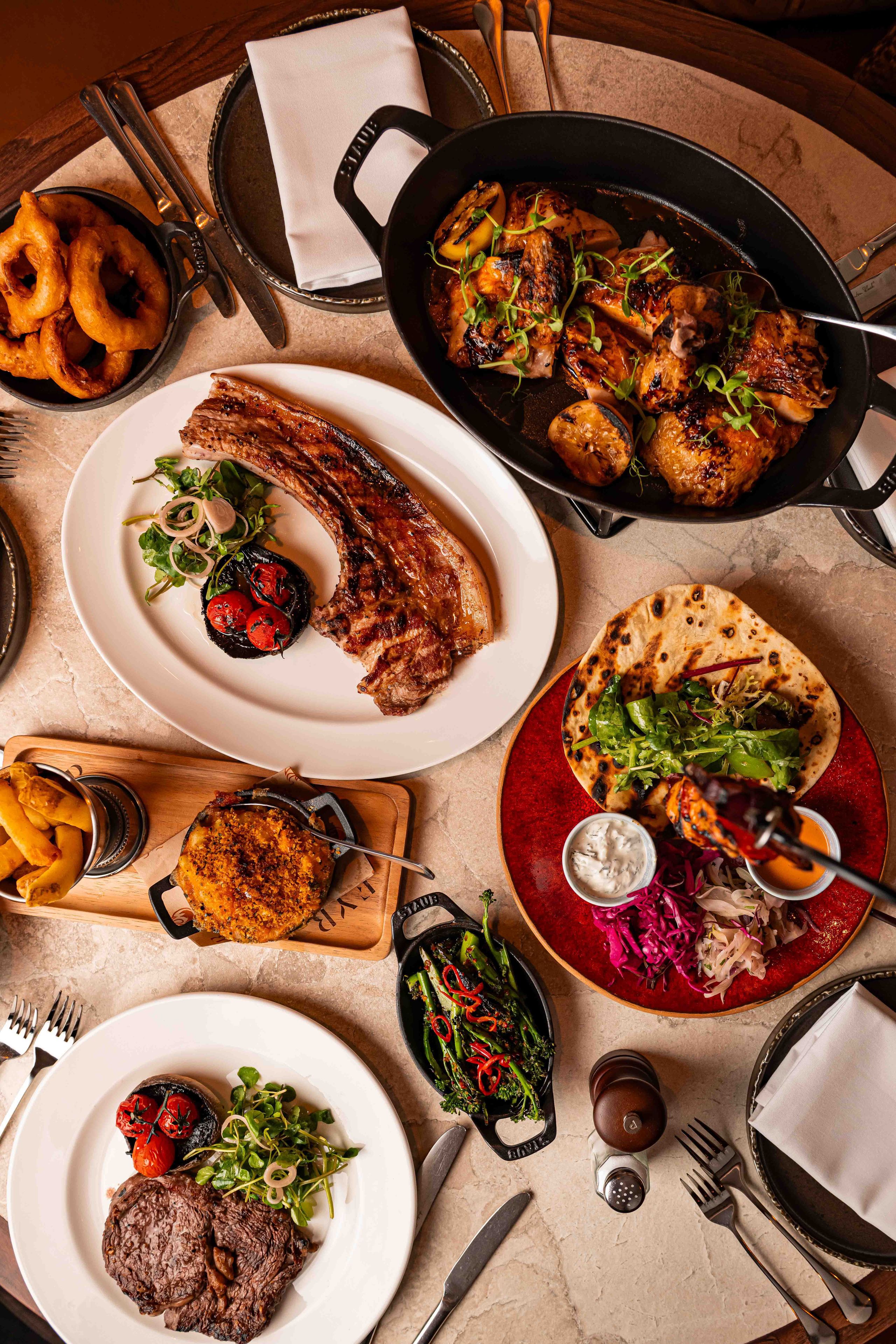 overview of different meal we have on the menus. Beer can Chicken, pork tomahawk, steak, chuck steak burger and the flatbread